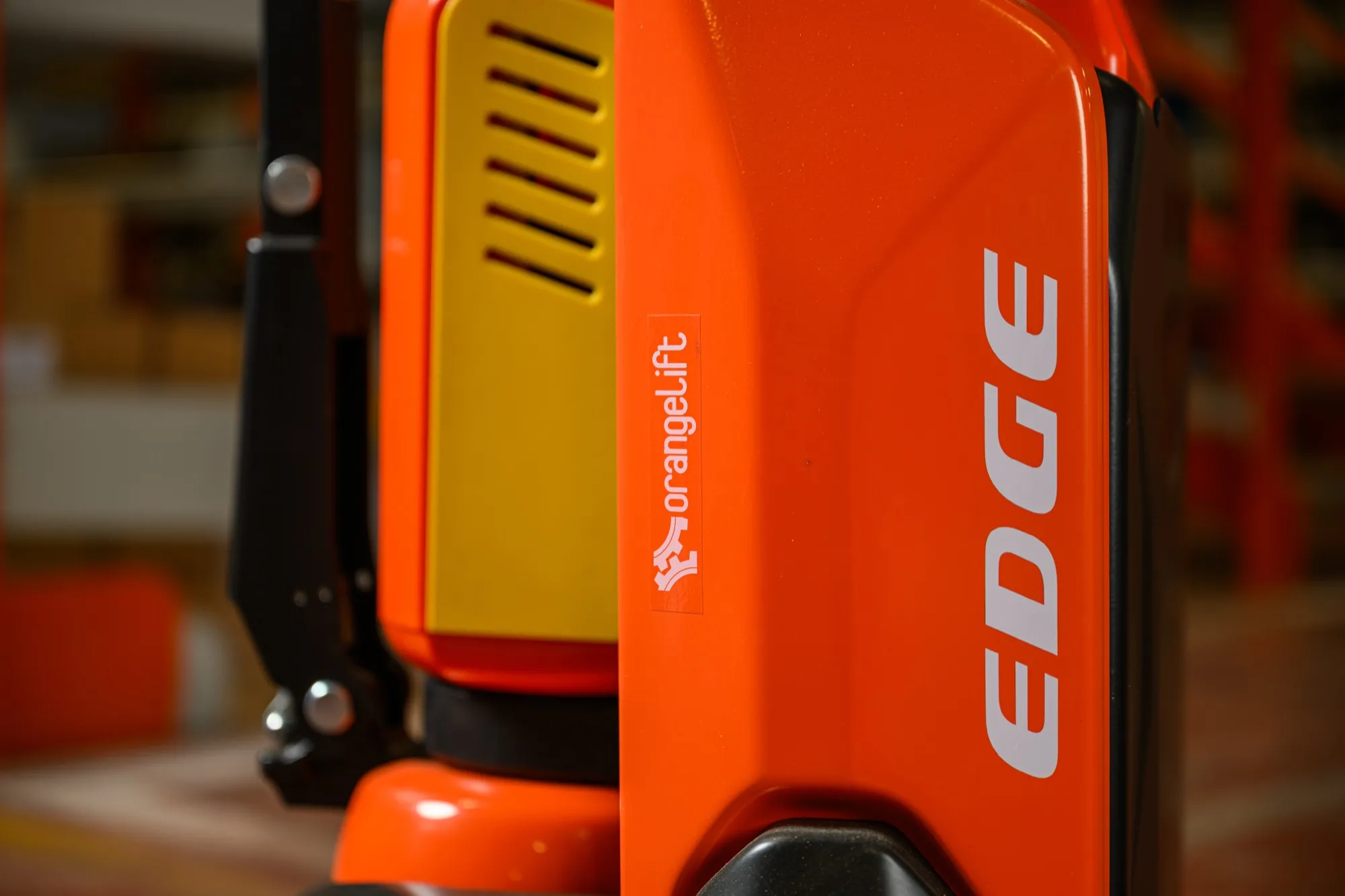 Dettaglio del transpallet elettrico Serie N OrangeLift, forche e gruppo batteria